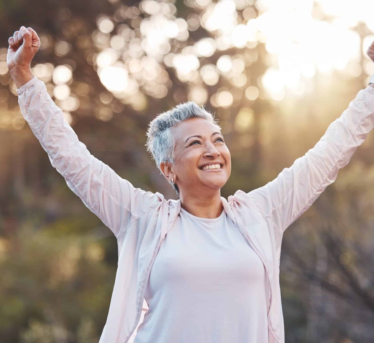 Senior woman, smile and nature while outdoor for freedom, happiness and a healthy lifestyle with fitness and fresh air. Face of happy black female at park for peace, health and wellness in summer.
